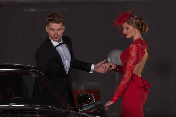 young elegance couple at the garage with her retro car - haute couture beautiful smoking beauty imagens e fotografias de stock