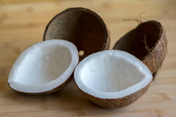 istock Coconut two halves with nutshells on wooden bambo table 1197007383