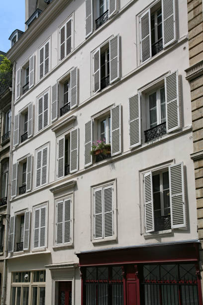 istock Paris, modern apartment building with louvered shutters on windows to keep out the sun 1197008338