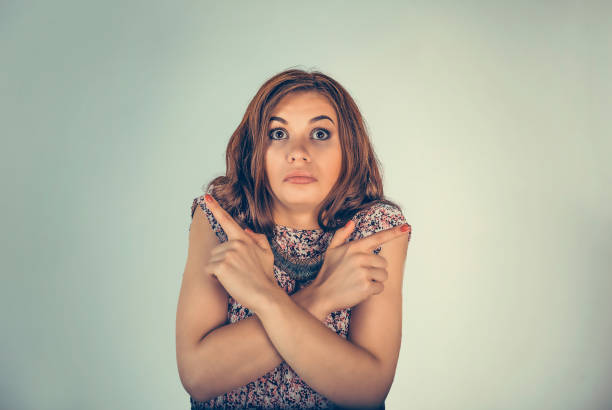 istock woman pointing in two different directions not sure which way to go 1197009151
