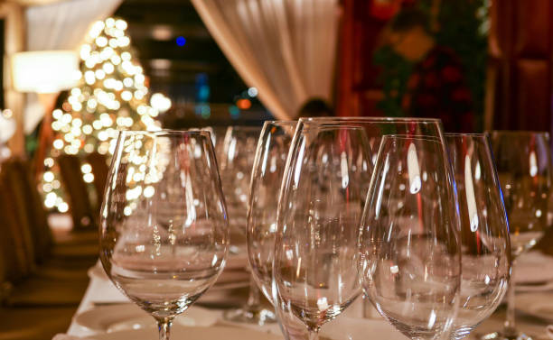 istock New year service in restaurant with transparent glasses, illuminated evergreen tree, multiple reflections and defocused background 1197009286