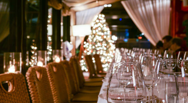 istock New year service in restaurant with transparent glasses, illuminated evergreen tree, multiple reflections and defocused background 1197009287