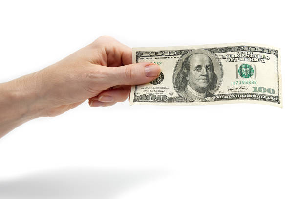 istock Finance wealth human hand holding dollar currency. isolated on white 1197012610