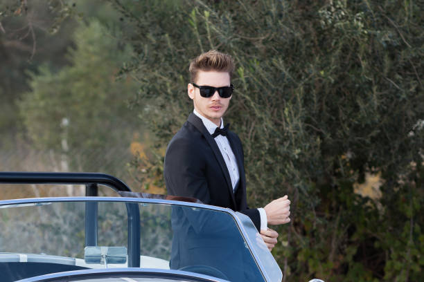 istock Handsome man driving a vintage car 1197013123