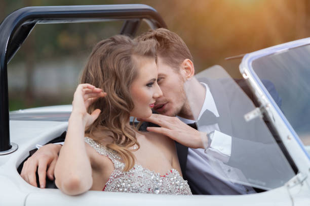istock Young elegance couple at the white vintage car 1197015749