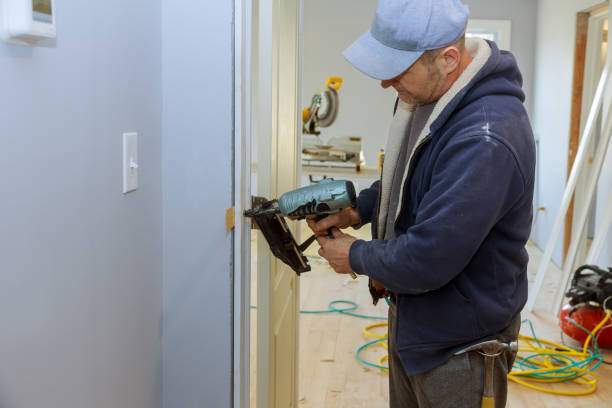 istock Construction interior install the door new home carpenter using air nail gun 1197015794