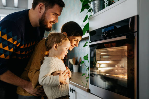 istock Young family looking at the oven 1197015798