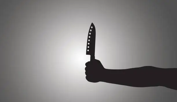 Photo of Shadow in the form of hands with a knife on a white background