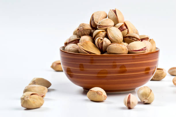 istock Pistachio in bowl on white background 1197017055