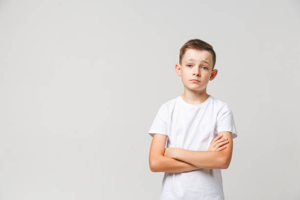 istock Sad young boy portrait on white background with copyspace 1197017128