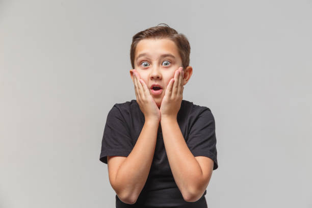 istock Boy is surprised and shocked, puts hands on head in disbelief. 1197017147