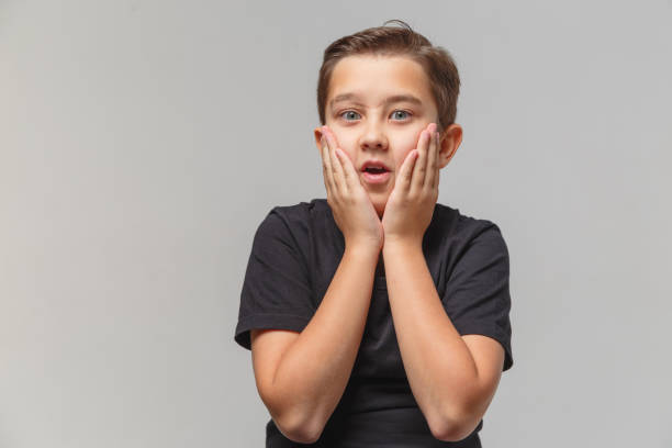 istock Boy is surprised and shocked, puts hands on head in disbelief. 1197017150