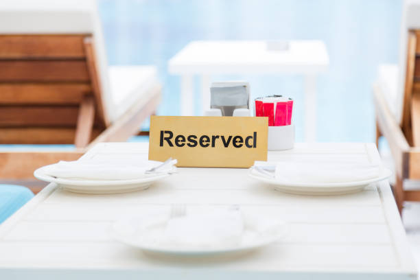 istock Reserved table in the lounge area by the pool. 1197017160