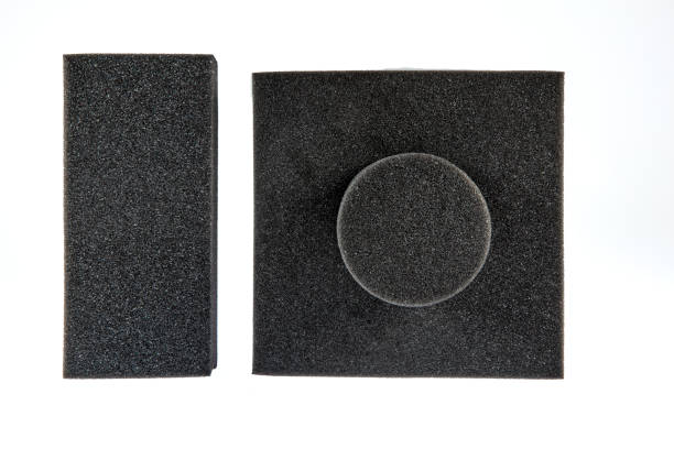 Black sponge foam in a shape of electronic or computer part, a protective equipment on white background.