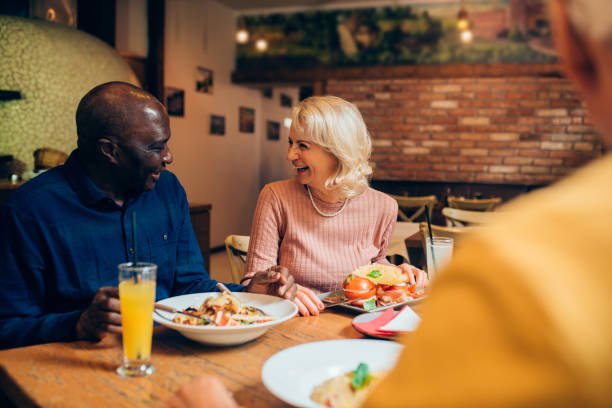 istock Seniors enjoying dinner at the restaurant together 1197022162