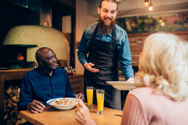 istock Multi - ethnic senior couple getting their order at the restaurant 1197022171