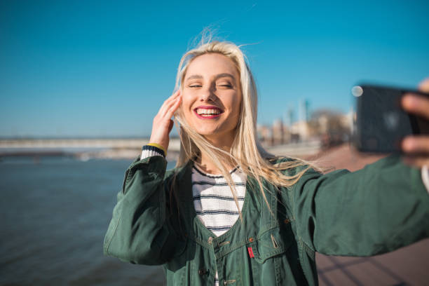 istock Cute girl on vacation taking a selfie 1197022428