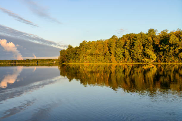 istock Autumn day trees reflecting in lake 1197024135