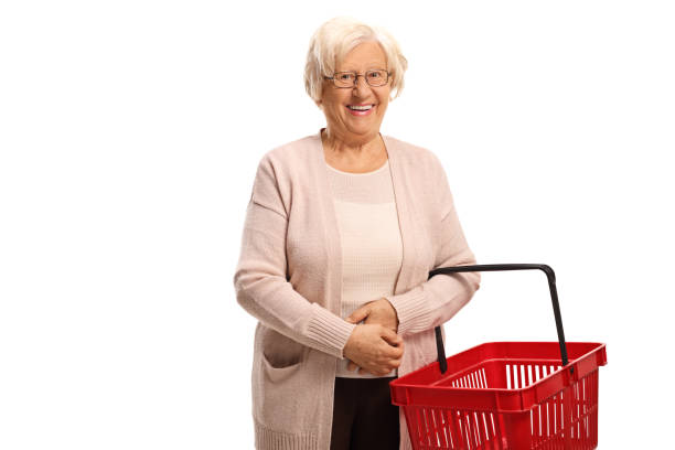 istock Senior lady smiling and holding an empty shopping basket 1197028302