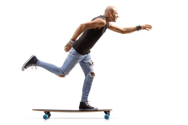 istock Bald hipster man riding a skateboard 1197028311