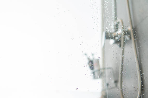 istock Abstract blurred bathroom interior Background. Empty white marble tile for product display with window bokeh focus concept for hotel spa. luxury interior home restroom 1197042989