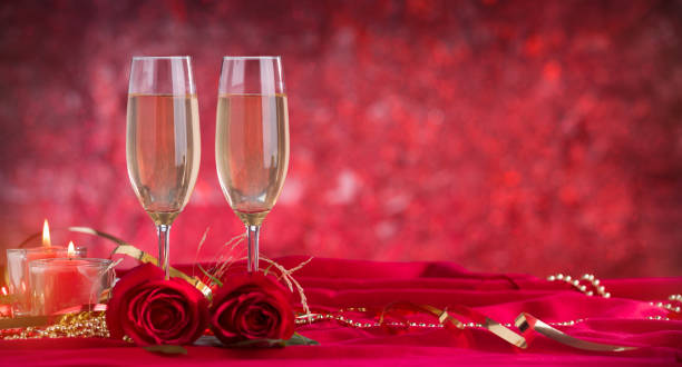 istock Champagne glass and roses on velvet drape 1197045557