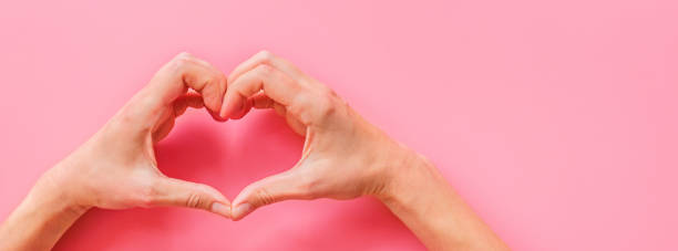 istock Valentine's day background. Female hands making hearth shape. Flat lay, top view, mockup, template, copy space. Minimal abstract composition for 14 February celebration 1197050363