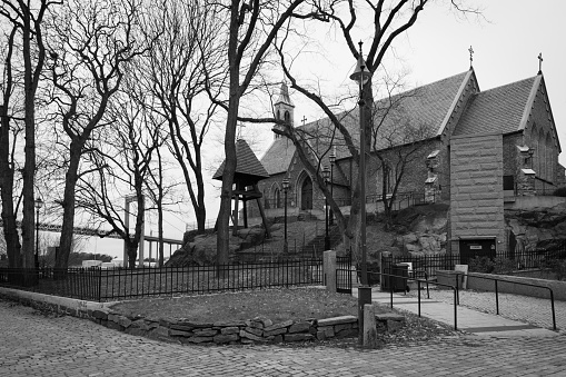 a black and white picture of an old church with some trees in front of it.