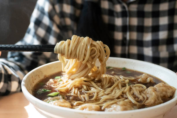 istock eating Chinese noodles in restaurant 1197061320