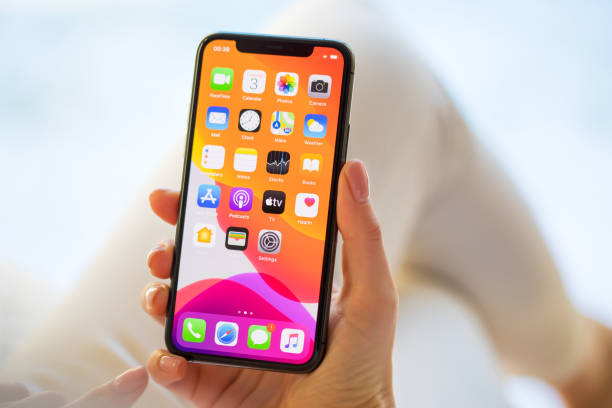 Woman using Apple iPhone 11 Pro smartphone Riga, Latvia - December 3, 2019: Woman using Apple iPhone 11 Pro. iphone stock pictures, royalty-free photos & images