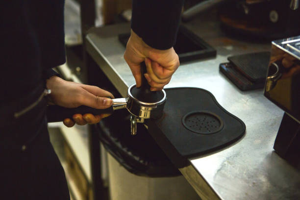 istock Barista presses ground coffee 1197063489