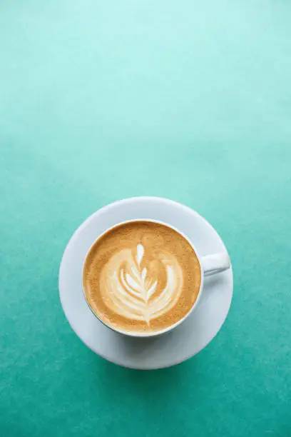 Photo of Fresh coffee on a mint background