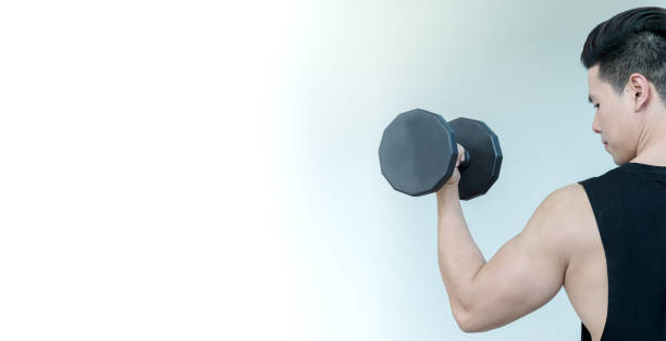 istock sportsman working out by black dumbbell with copy space for text 1197064370