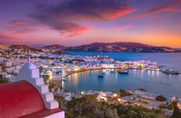 Photo of Mykonos port with boats and windmills at evening, Cyclades islands, Greece