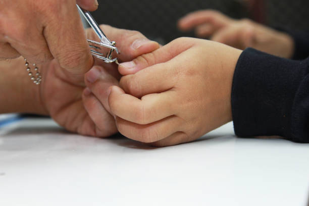istock Father to cut nails Son fingers 1197065544