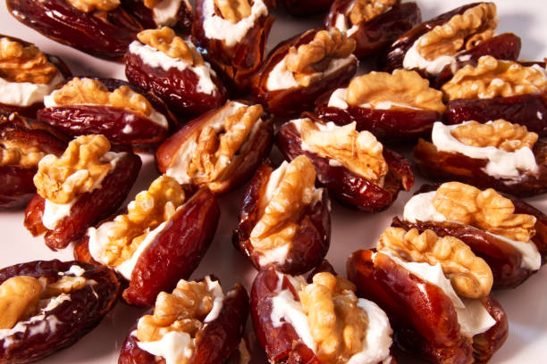 istock Fresh dates filled with mascarpone cheese and walnuts in a white dish. 1197067205