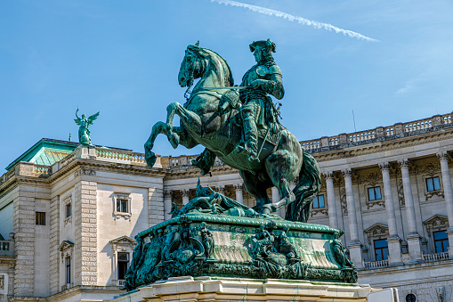 Vienna, Austria  - September 16, 2019: Statue of Kaiser Joseph II (1741-1790) in the Josefplatz in Vienna, Austria; the building behind the emperor houses the National Library of the imperial Hofburg.
