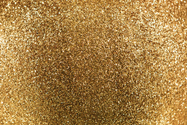 istock Golden sparkles glowing background 1197072932