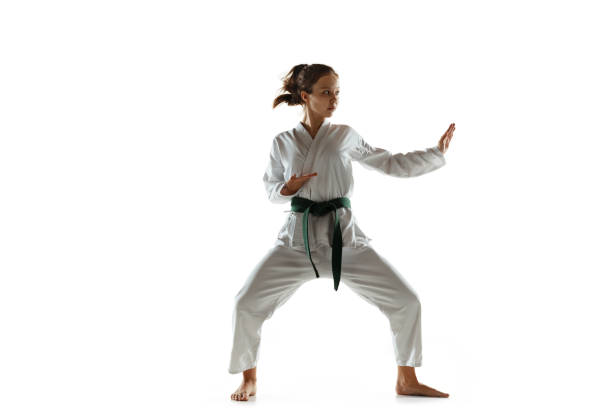 istock Confident junior in kimono practicing hand-to-hand combat, martial arts 1197073155