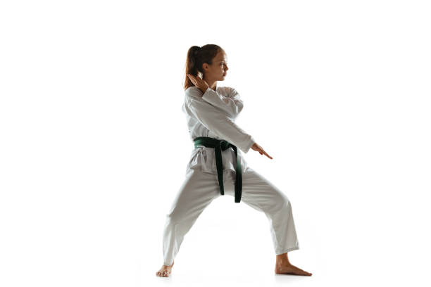 istock Confident junior in kimono practicing hand-to-hand combat, martial arts 1197073158
