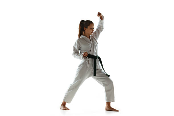 istock Confident junior in kimono practicing hand-to-hand combat, martial arts 1197073159