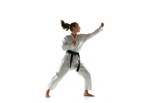 istock Confident junior in kimono practicing hand-to-hand combat, martial arts 1197073164
