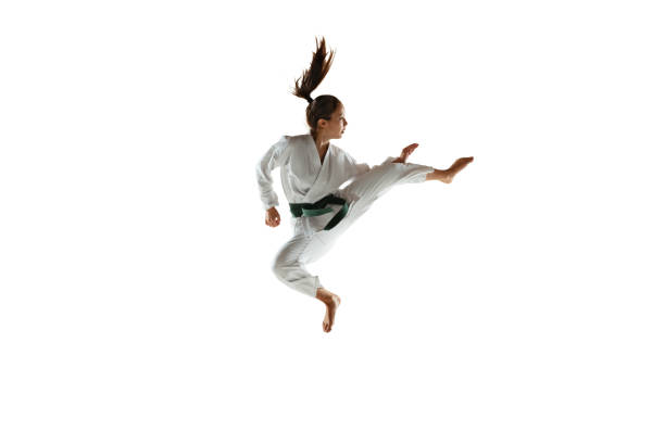 istock Confident junior in kimono practicing hand-to-hand combat, martial arts 1197073172