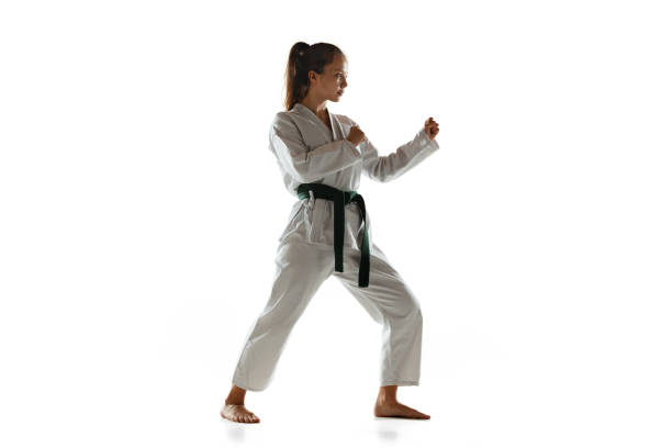 istock Confident junior in kimono practicing hand-to-hand combat, martial arts 1197073215