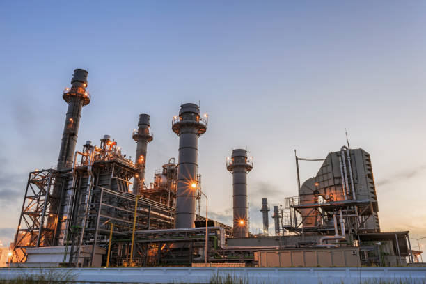 Gas turbine electrical power plant at dusk in the morning Gas turbine electrical power plant at dusk in the morning fumes photos stock pictures, royalty-free photos & images