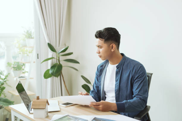 istock Young engineer. Successful busy man drawing something while working in the office 1197075672