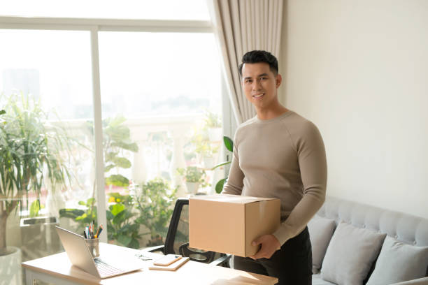 istock Young Man Holding Cardboxes, Indoors 1197076447