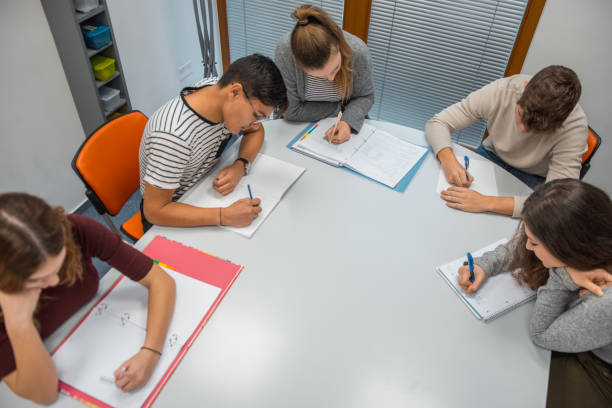 istock Group of students doing homework in the classroom 1197080388