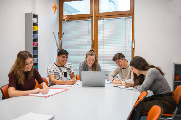 istock Group of students using laptop in the classroom 1197080493