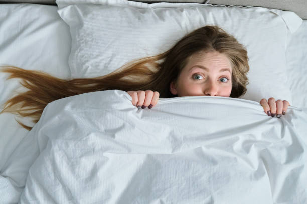 istock Young beautiful woman lying on pillow in bed, top view 1197080500